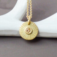 Orum-ethical-sun-amulet-made-with-18ct-Fairtrade-gold-and-a-yellow-diamond-1-scaled