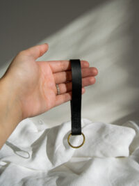 black-brass-key-fob-in-hand